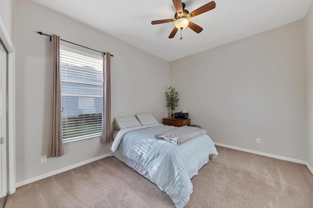 9910 Laurel Valley Ave Circle Bradenton, FL 34202 - Photo 28 of 37 a bedroom with a bed and a chandelier