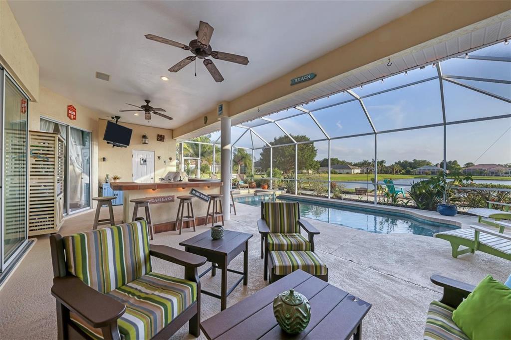 9910 Laurel Valley Ave Circle Bradenton, FL 34202 - Photo 30 of 37 a dining room with furniture a floor to ceiling window and potted plants