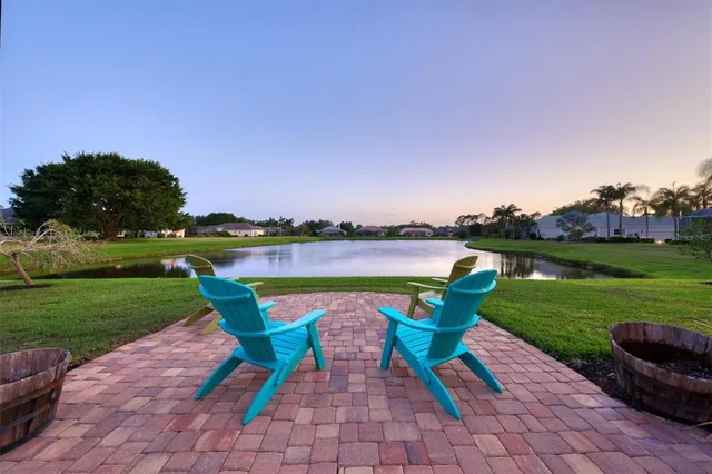 a view of a house with a yard and a fountain