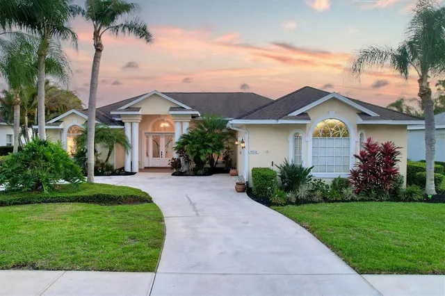 a front view of a house with a garden