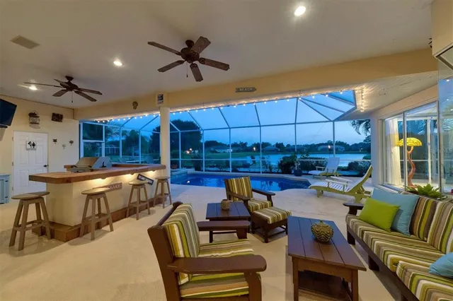 a living room with furniture a large window with outer view