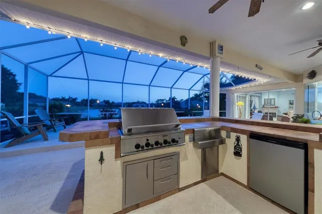 a kitchen that has a sink and a stove top oven