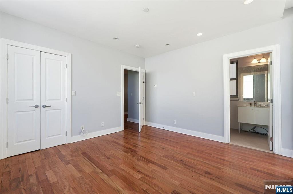 8125 River Road, Unit 4E North Bergen, NJ 07047 - Photo 14 of 35 a view of an empty room with wooden floor and a bathroom