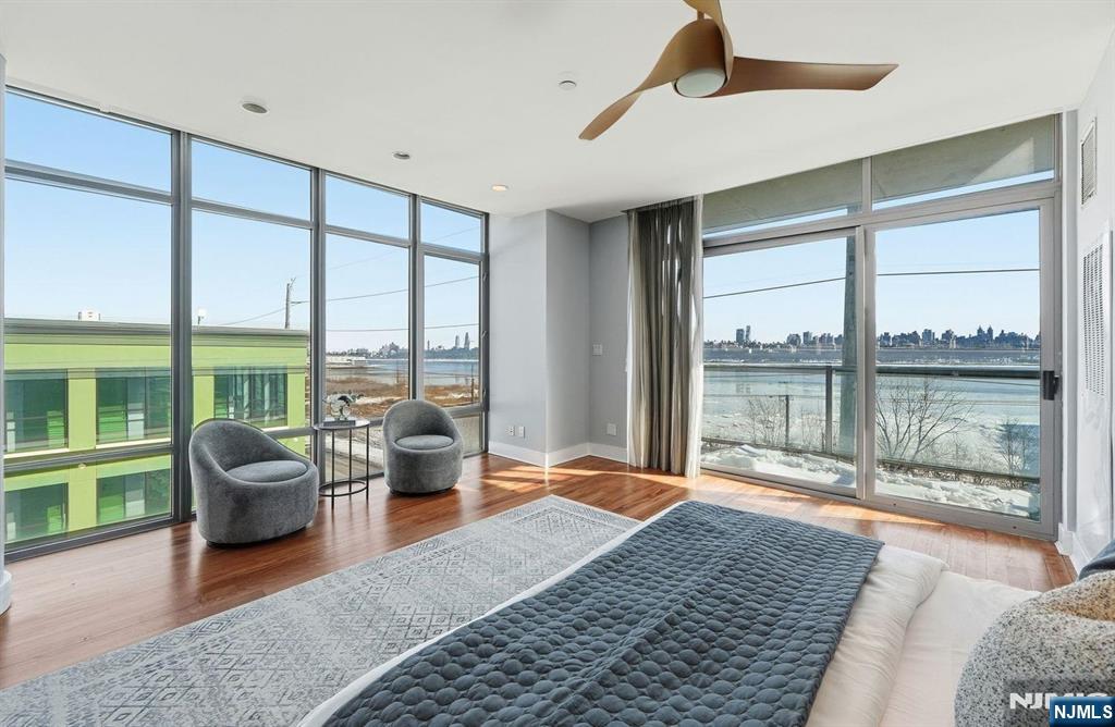8125 River Road, Unit 4E North Bergen, NJ 07047 - Photo 20 of 35 a bedroom with furniture and large windows