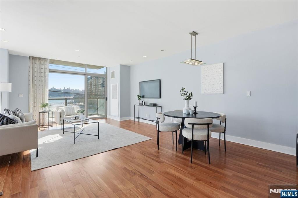 8125 River Road, Unit 4E North Bergen, NJ 07047 - Photo 2 of 35 a living room with furniture a table and wooden floor