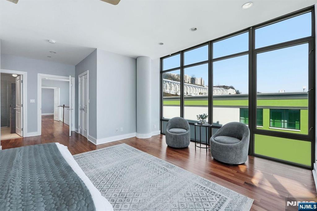 8125 River Road, Unit 4E North Bergen, NJ 07047 - Photo 22 of 35 a living room with furniture and a floor to ceiling window