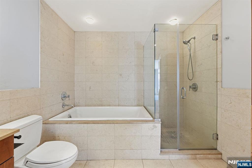 8125 River Road, Unit 4E North Bergen, NJ 07047 - Photo 25 of 35 a bathroom with a toilet and shower