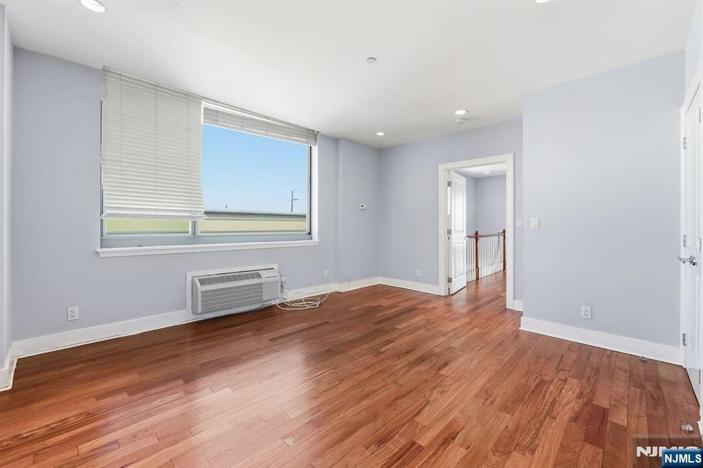 8125 River Road, Unit 4E North Bergen, NJ 07047 - Photo 28 of 35 a view of an empty room with wooden floor and a window