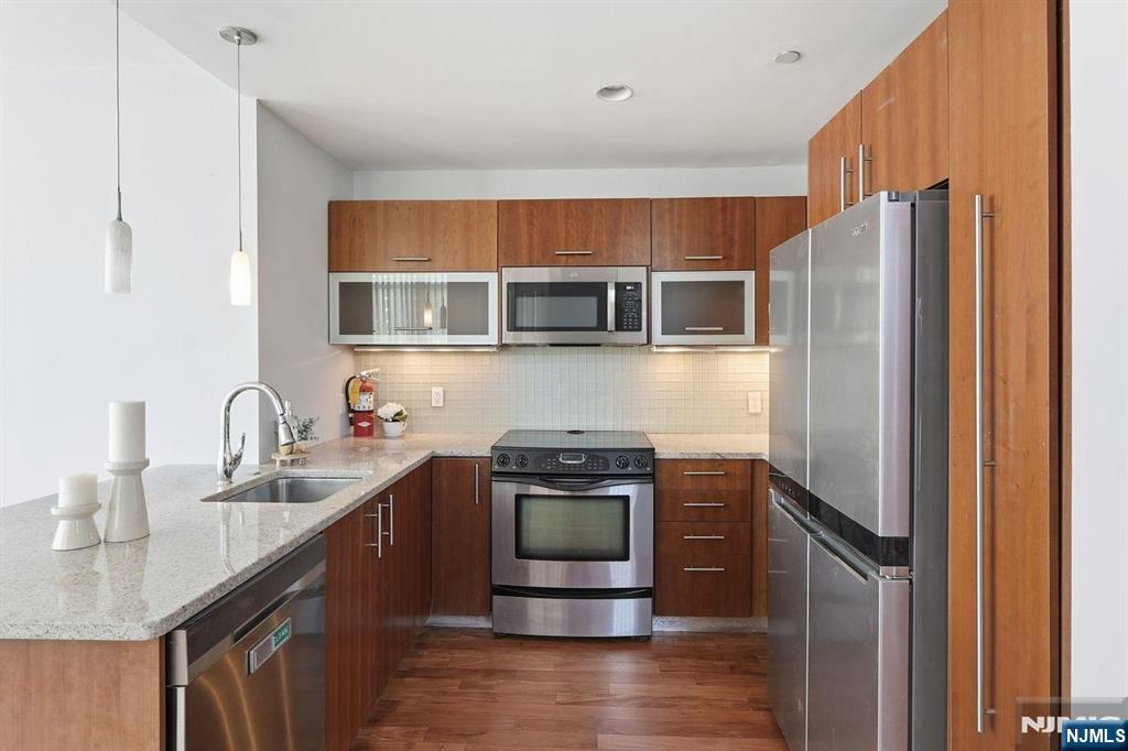 8125 River Road, Unit 4E North Bergen, NJ 07047 - Photo 10 of 35 a kitchen with a sink stove and refrigerator