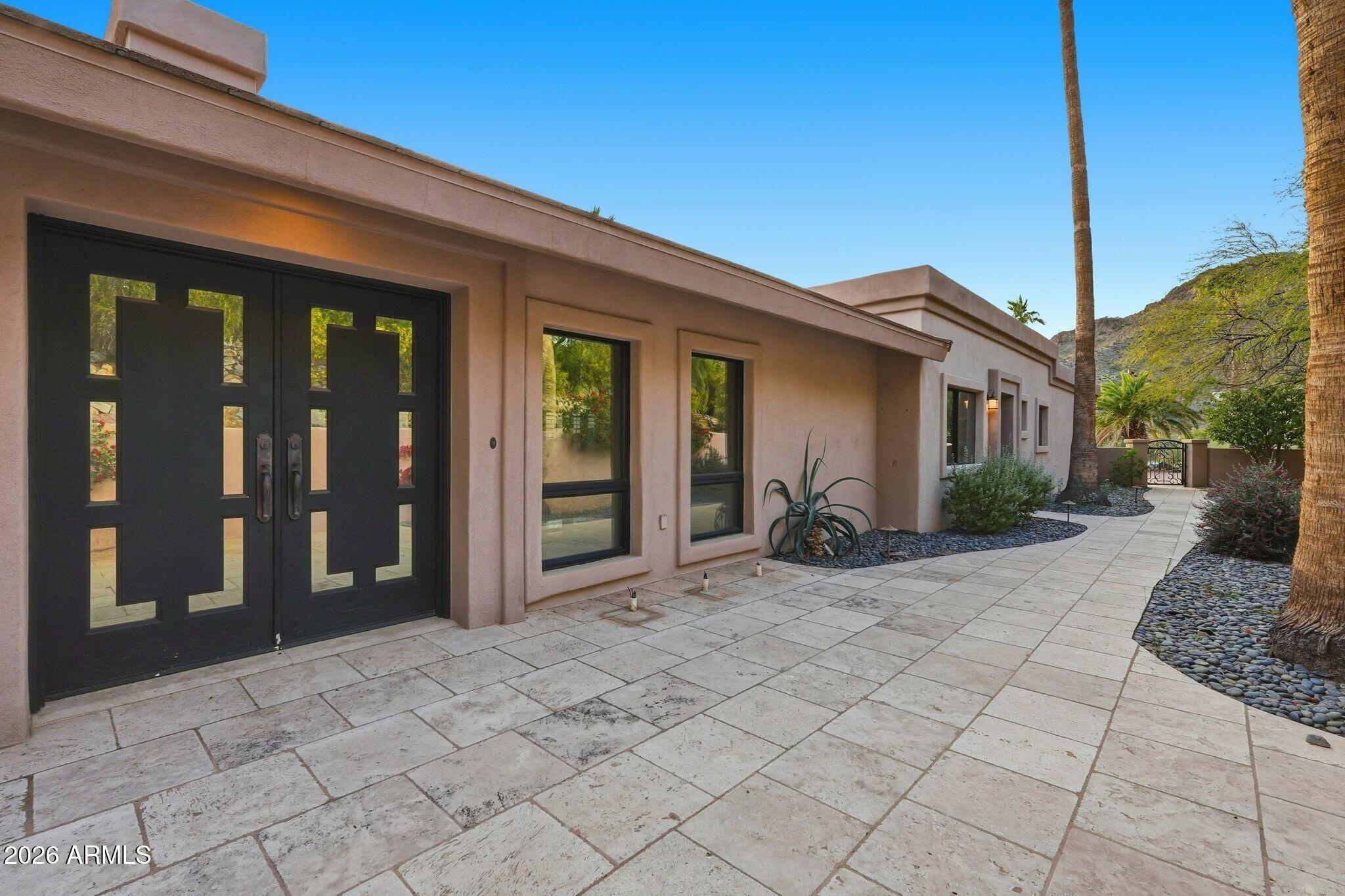 4021 East Lamar Road Paradise Valley, AZ 85253 - Photo 13 of 48 a view of a house with backyard porch and glass door