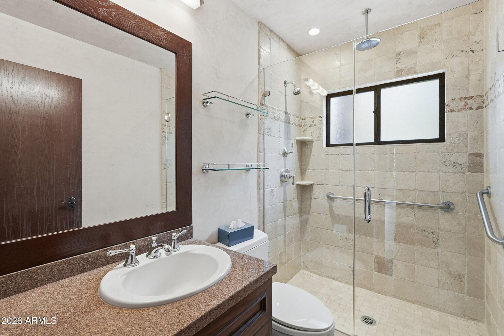 4021 East Lamar Road Paradise Valley, AZ 85253 - Photo 24 of 48 a bathroom with a sink toilet a mirror and shower