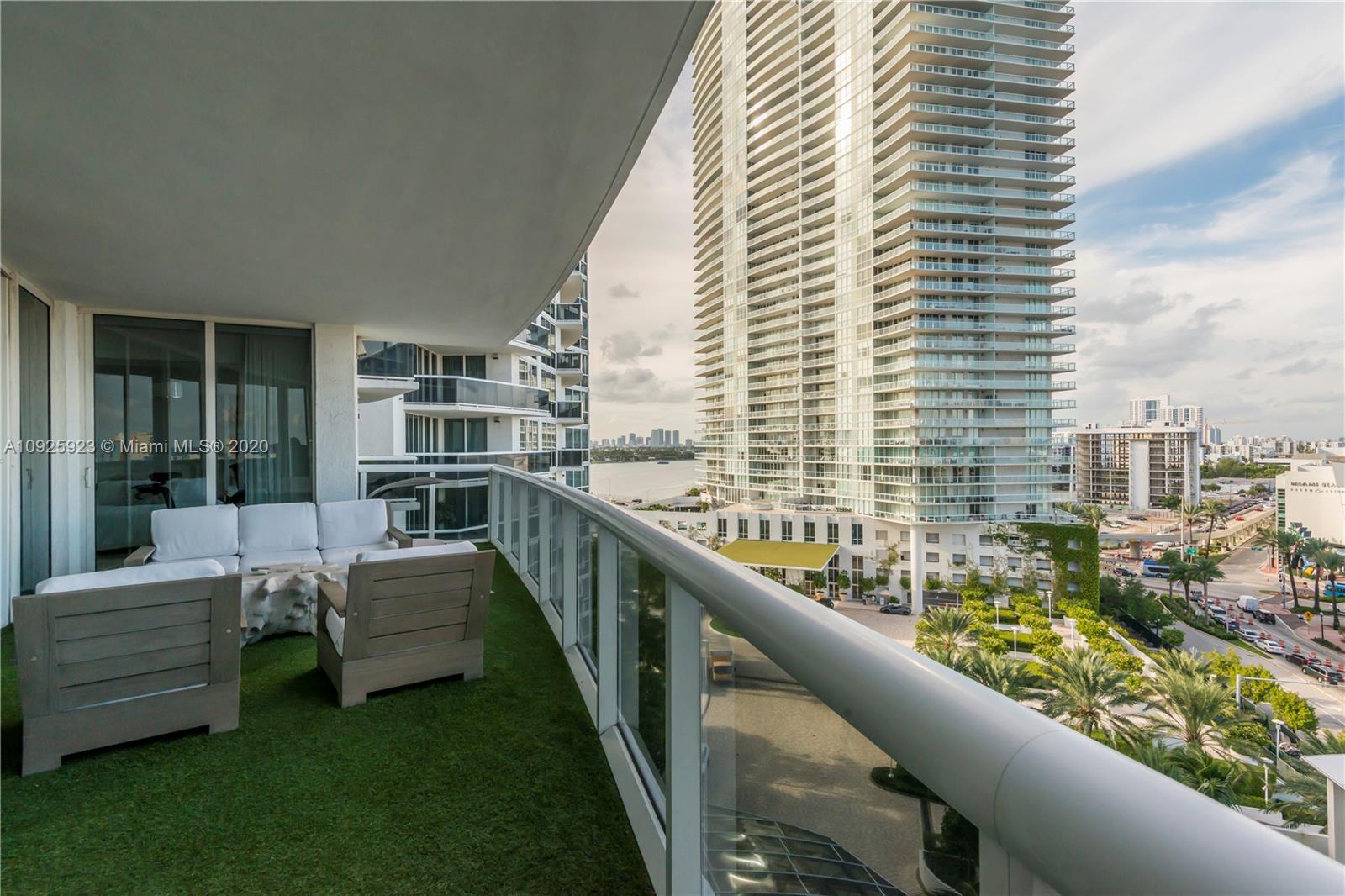 400 Alton Road, Unit 1007 Miami Beach, FL 33139 - Photo 12 of 13 a view of a balcony with two chairs and a large window