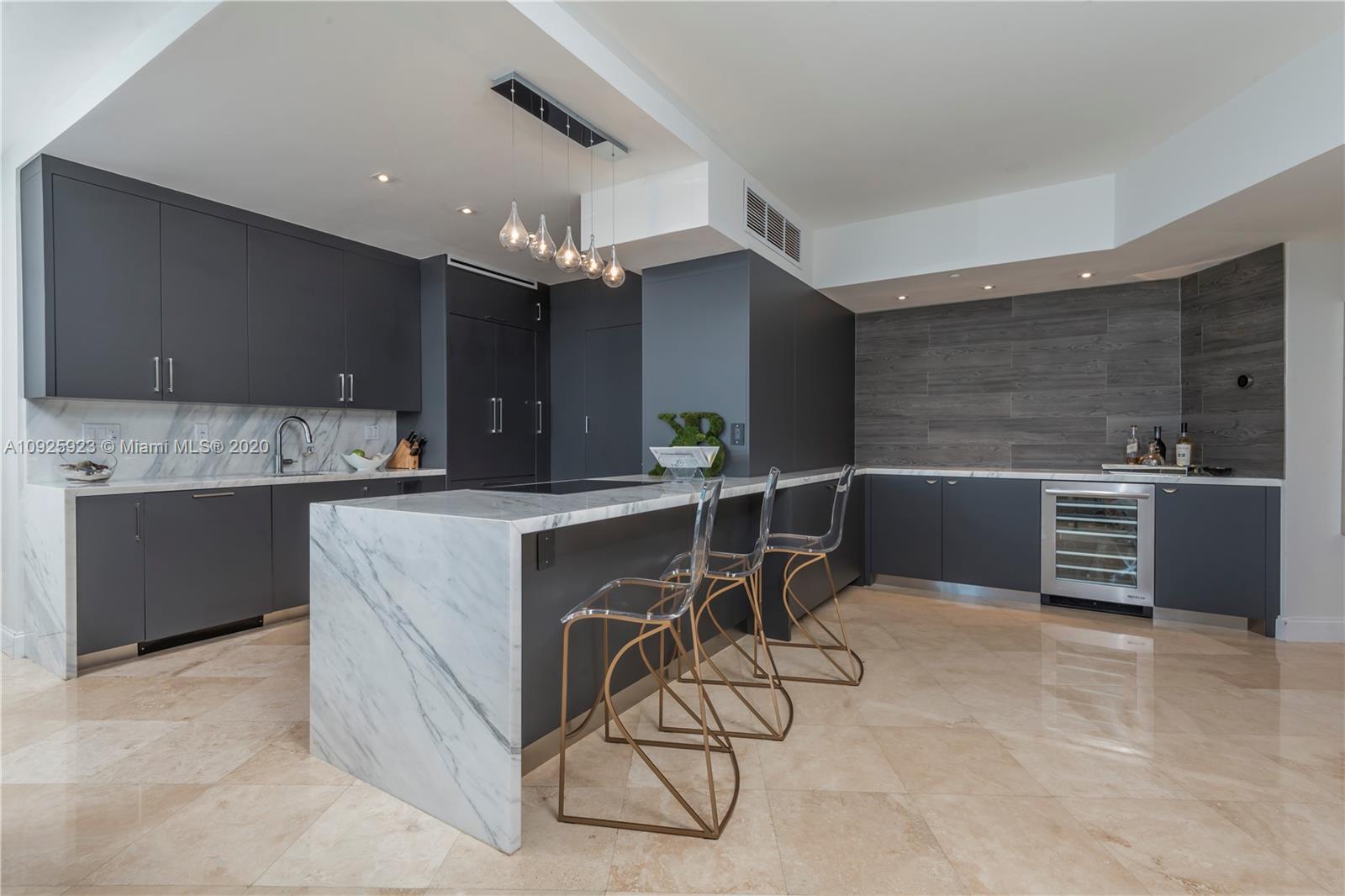 400 Alton Road, Unit 1007 Miami Beach, FL 33139 - Photo 2 of 13 a kitchen with stainless steel appliances kitchen island granite countertop a sink and a stove