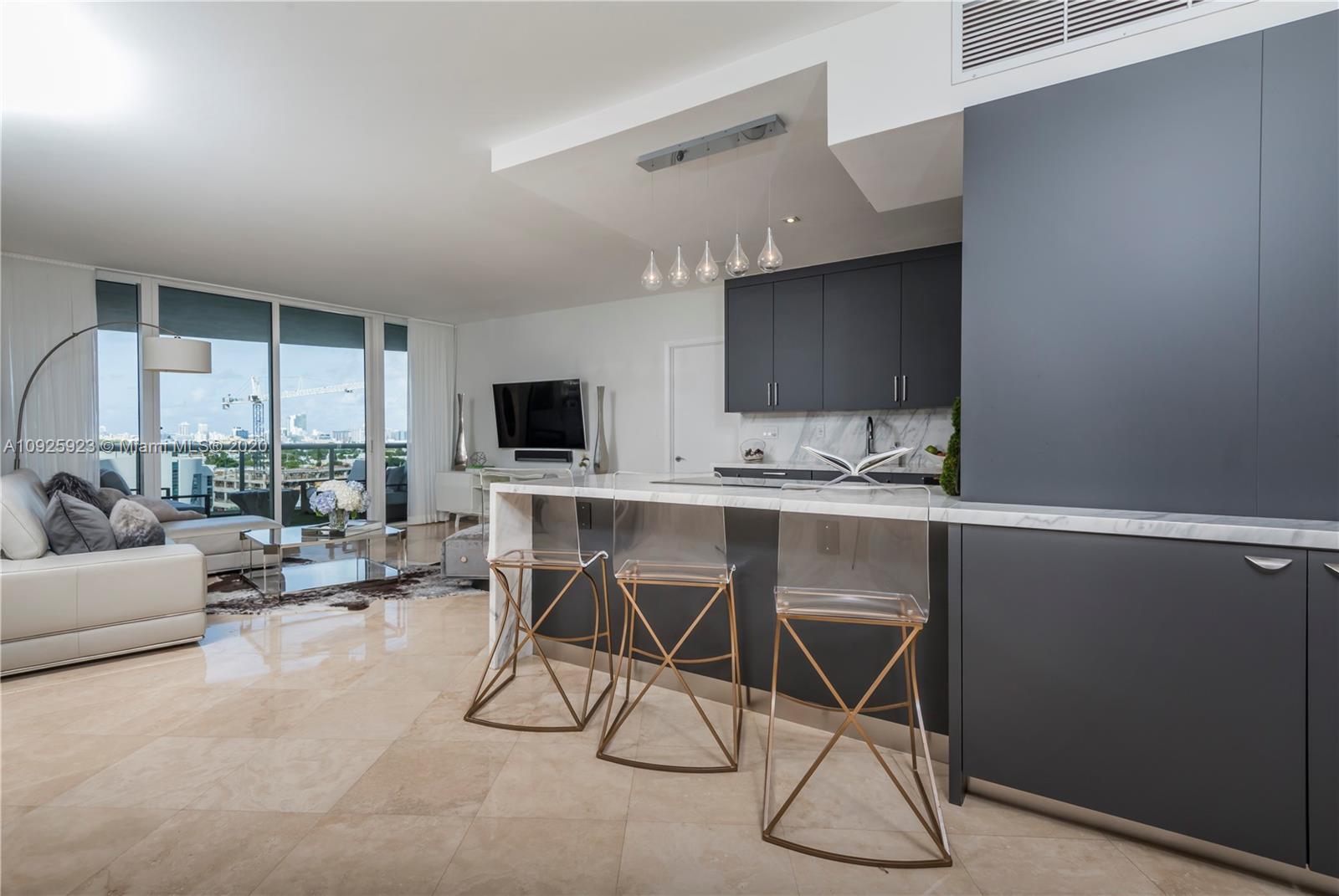 400 Alton Road, Unit 1007 Miami Beach, FL 33139 - Photo 4 of 13 a living room with a flat screen tv and white floor