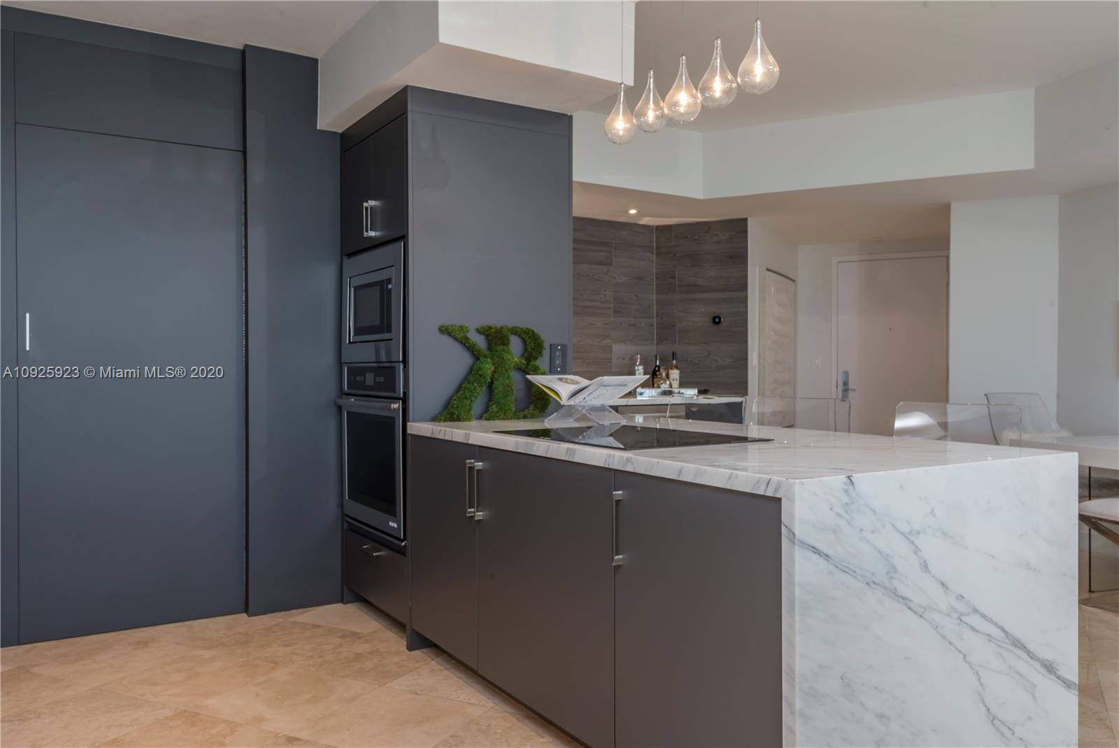 400 Alton Road, Unit 1007 Miami Beach, FL 33139 - Photo 5 of 13 a kitchen with a sink and chandelier