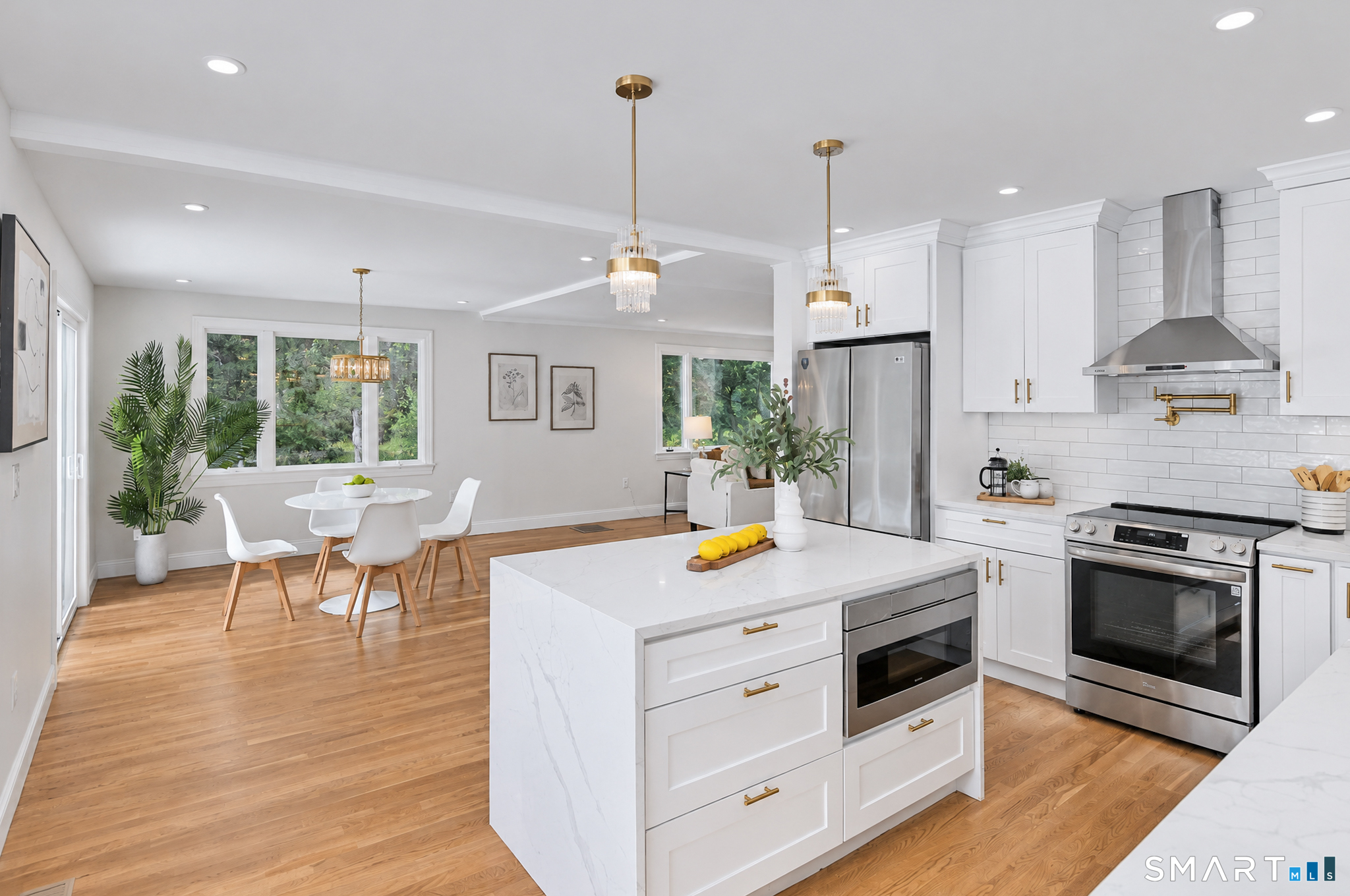 34 Rimmon Road Woodbridge, CT 06525 - Photo 15 of 40 White cabinetry, quartz-style countertops, stainless steel appliances and brass accents.
