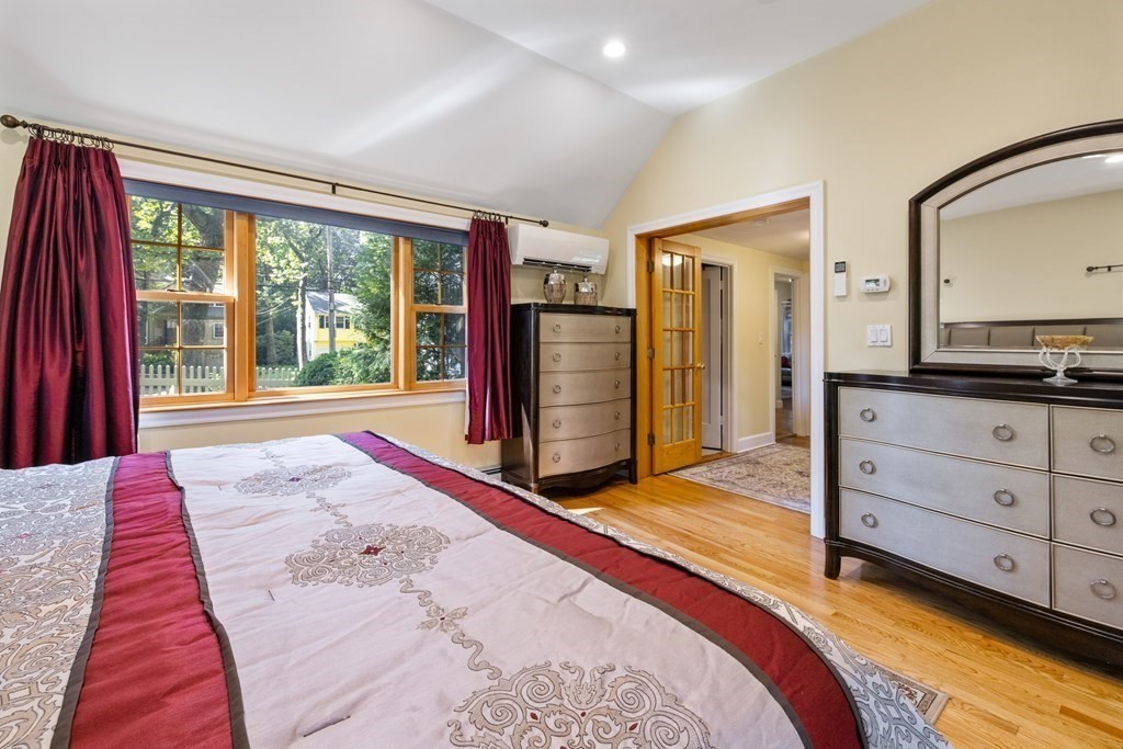 46 Spring Street Lexington, MA 02421 - Photo 17 of 32 a bedroom with a bed and large windows