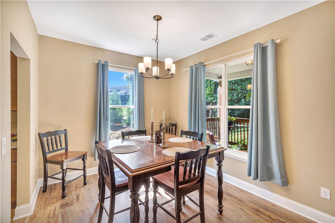3004 Cobbs Way Anderson, SC 29621 - Photo 5 of 46 Rich wood flooring pairs beautifully with classic crown molding in this inviting dining space.