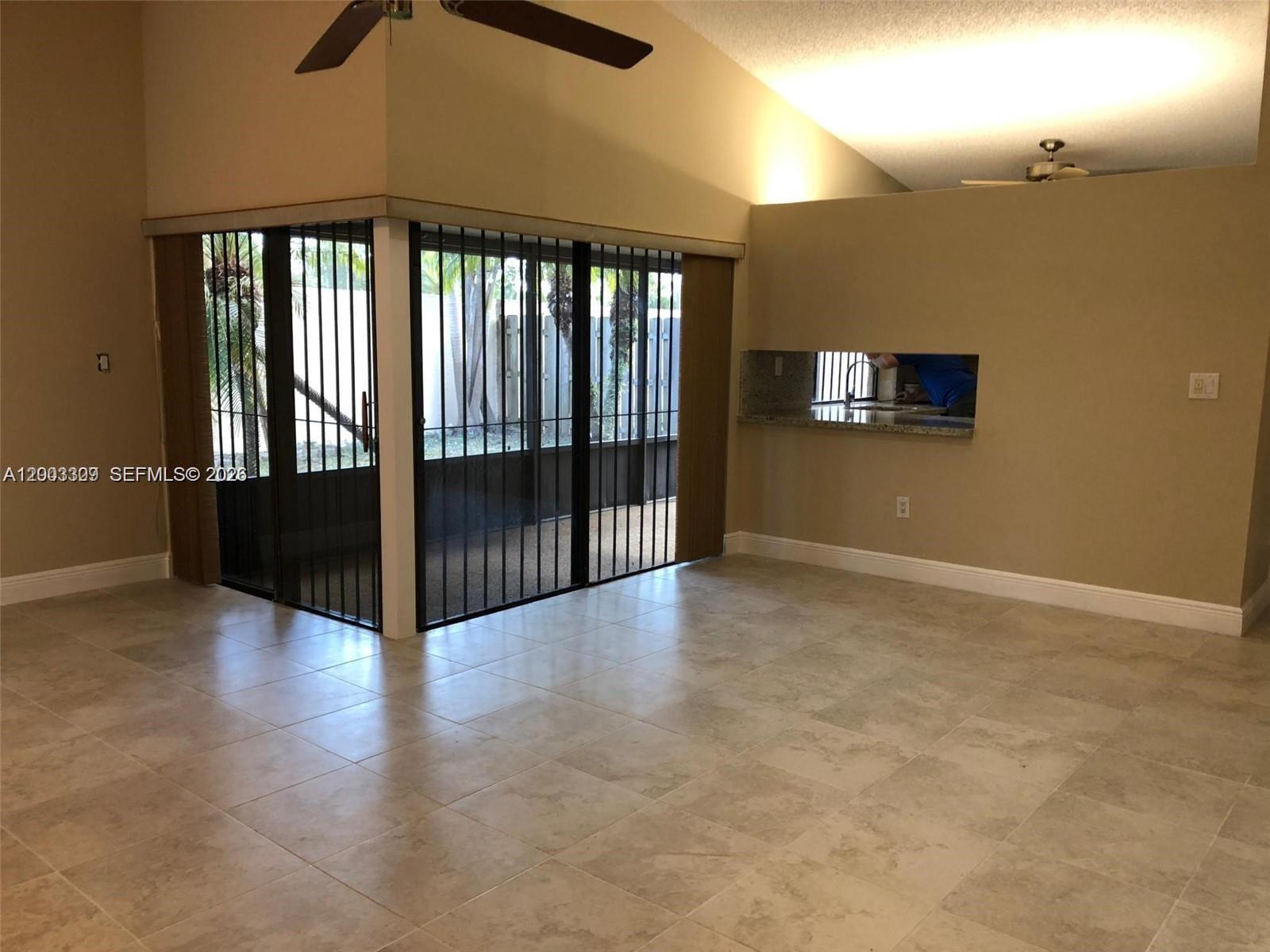 9164 Southwest 132nd Lane Miami, FL 33176 - Photo 7 of 15 wooden floor in an empty room with a window