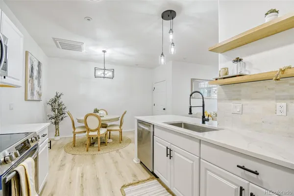a kitchen with sink cabinets and wooden floor