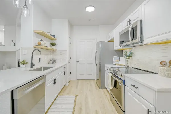 a kitchen with a sink stove and refrigerator