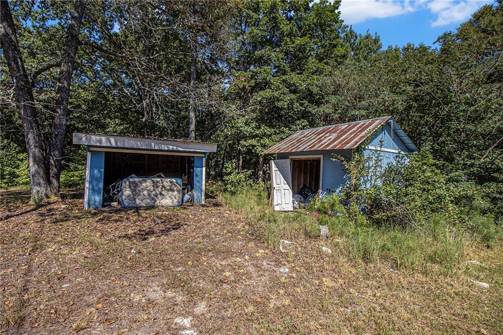 655 Hall Station Road Northwest Kingston, GA 30145 - Photo 14 of 17 a view of a house with a yard and a tree