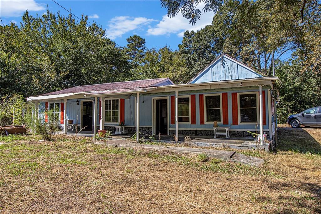 655 Hall Station Road Northwest Kingston, GA 30145 - Photo 17 of 17 a front view of a house with a porch and a yard
