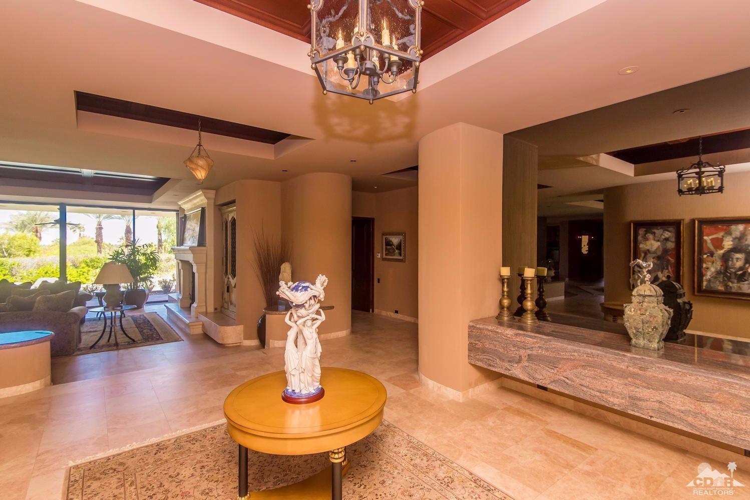 70416 Placerville Road Rancho Mirage, CA 92270 - Photo 12 of 32 a living room with fireplace furniture and a chandelier