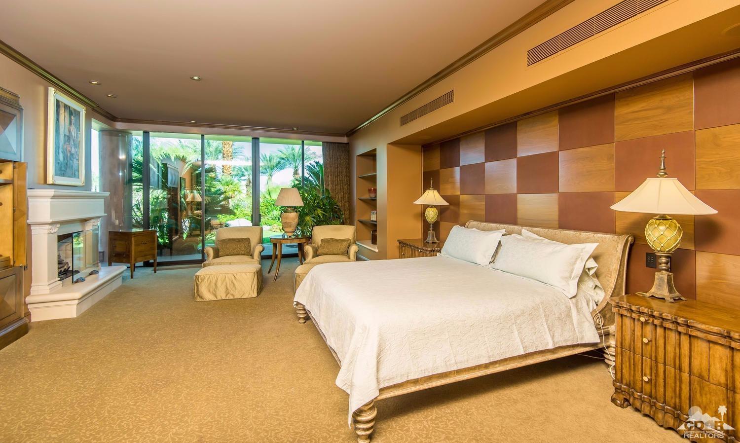 70416 Placerville Road Rancho Mirage, CA 92270 - Photo 17 of 32 a bed room with a bed and a chair