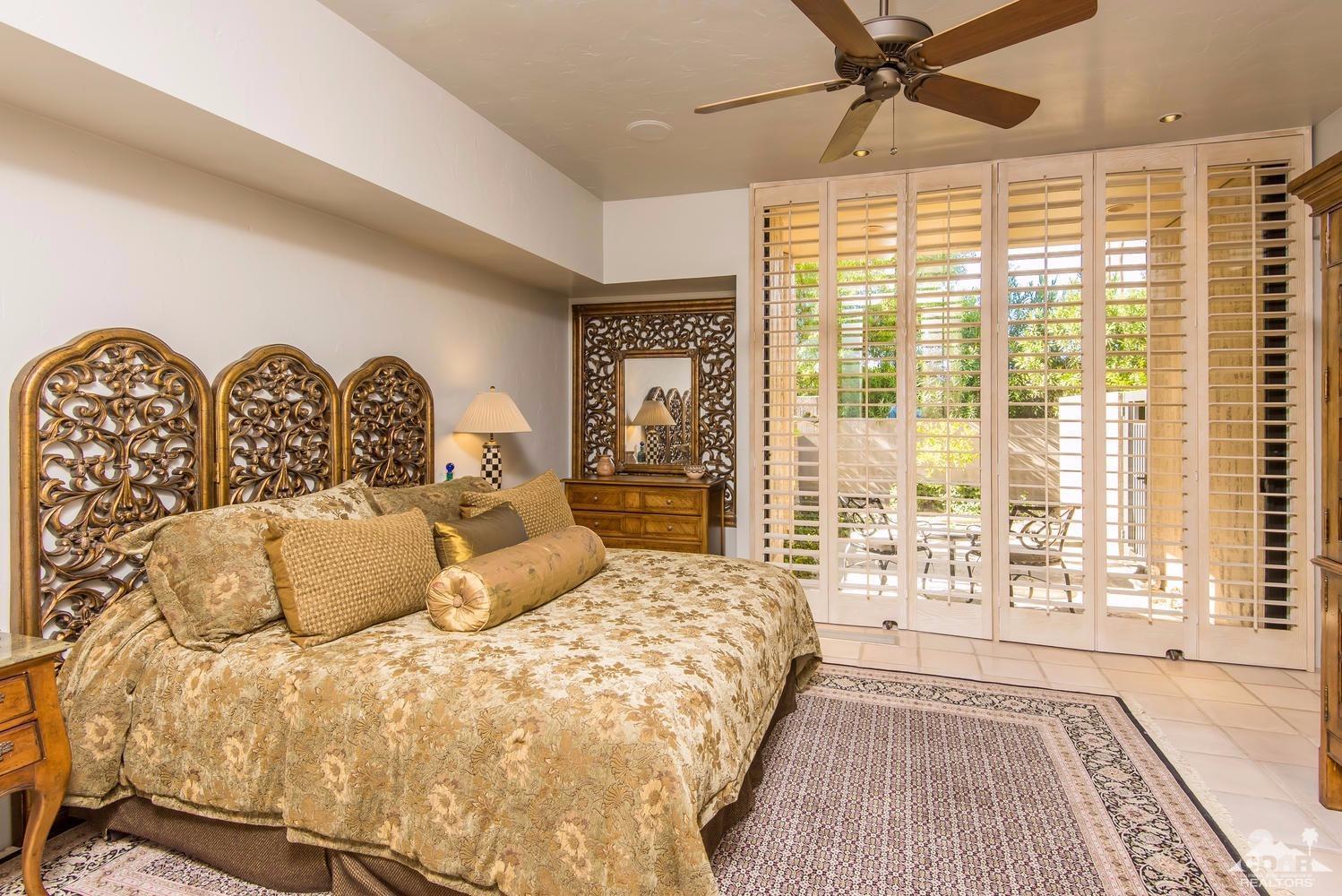 70416 Placerville Road Rancho Mirage, CA 92270 - Photo 24 of 32 a bedroom with a large bed and a large window