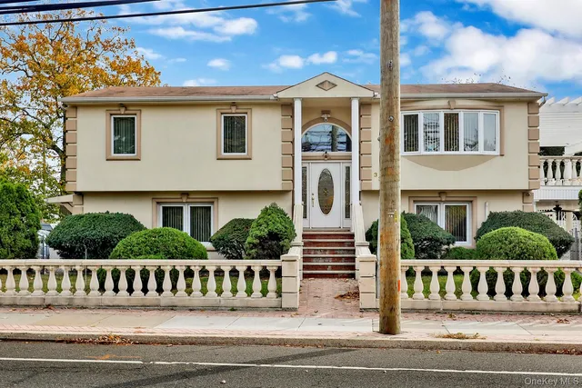 a view of a house with wooden fence