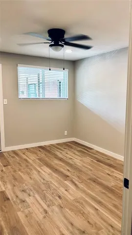 a view of a room with a wooden floor and cabinets