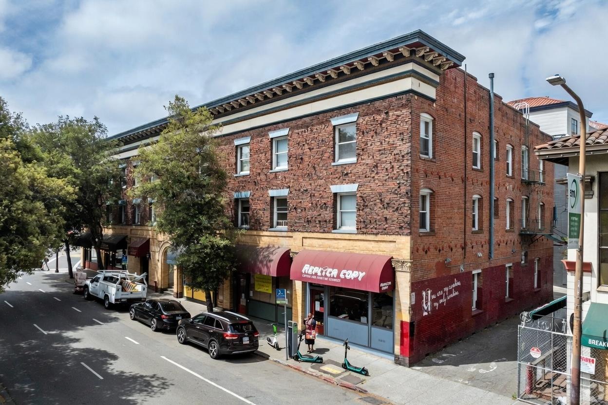 2171 Allston Way Berkeley, CA 94704 - Photo 10 of 10 a man walking down a street next to a building