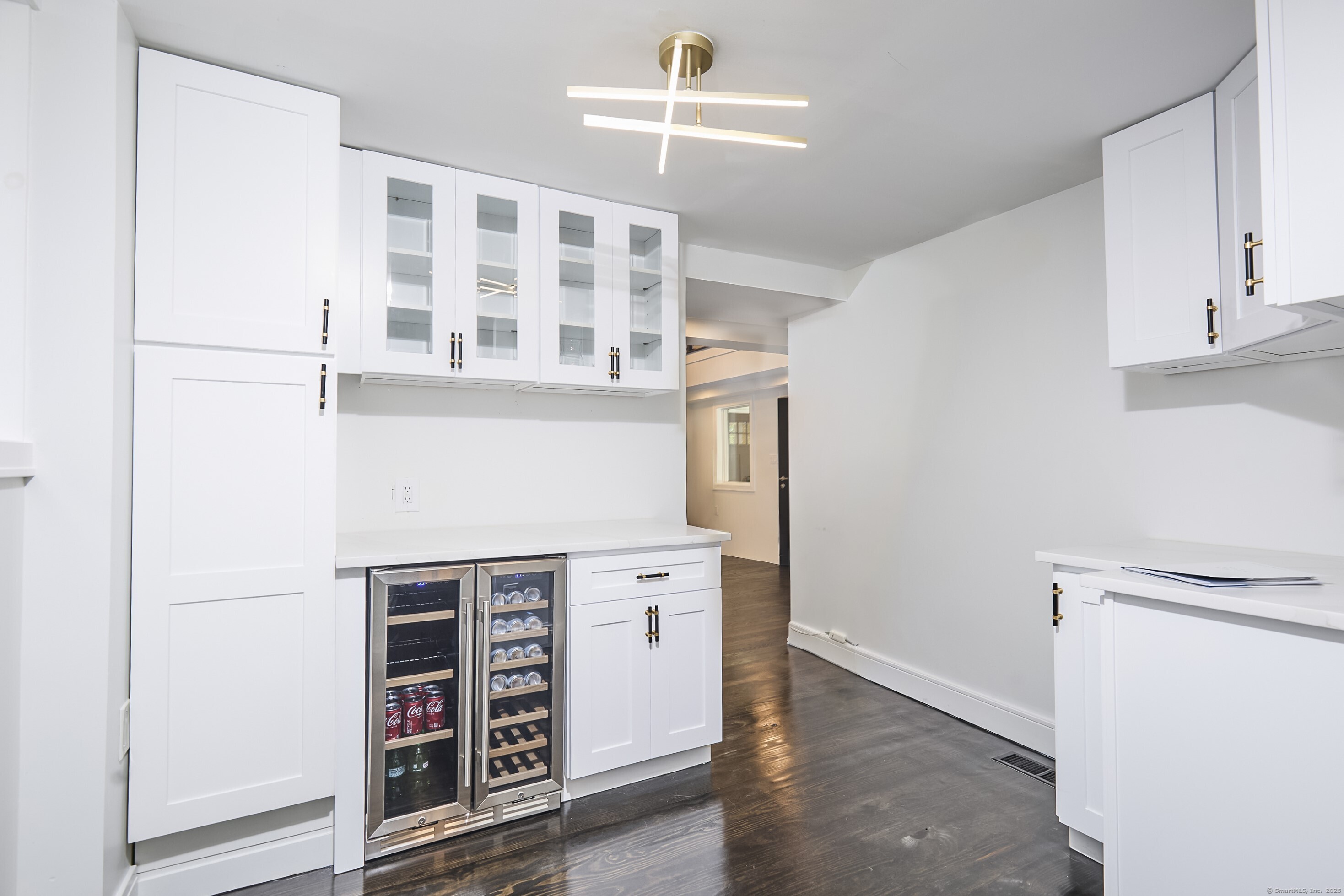 1207 Stillson Road Fairfield, CT 06824 - Photo 18 of 39 a kitchen with a stove cabinets and a refrigerator