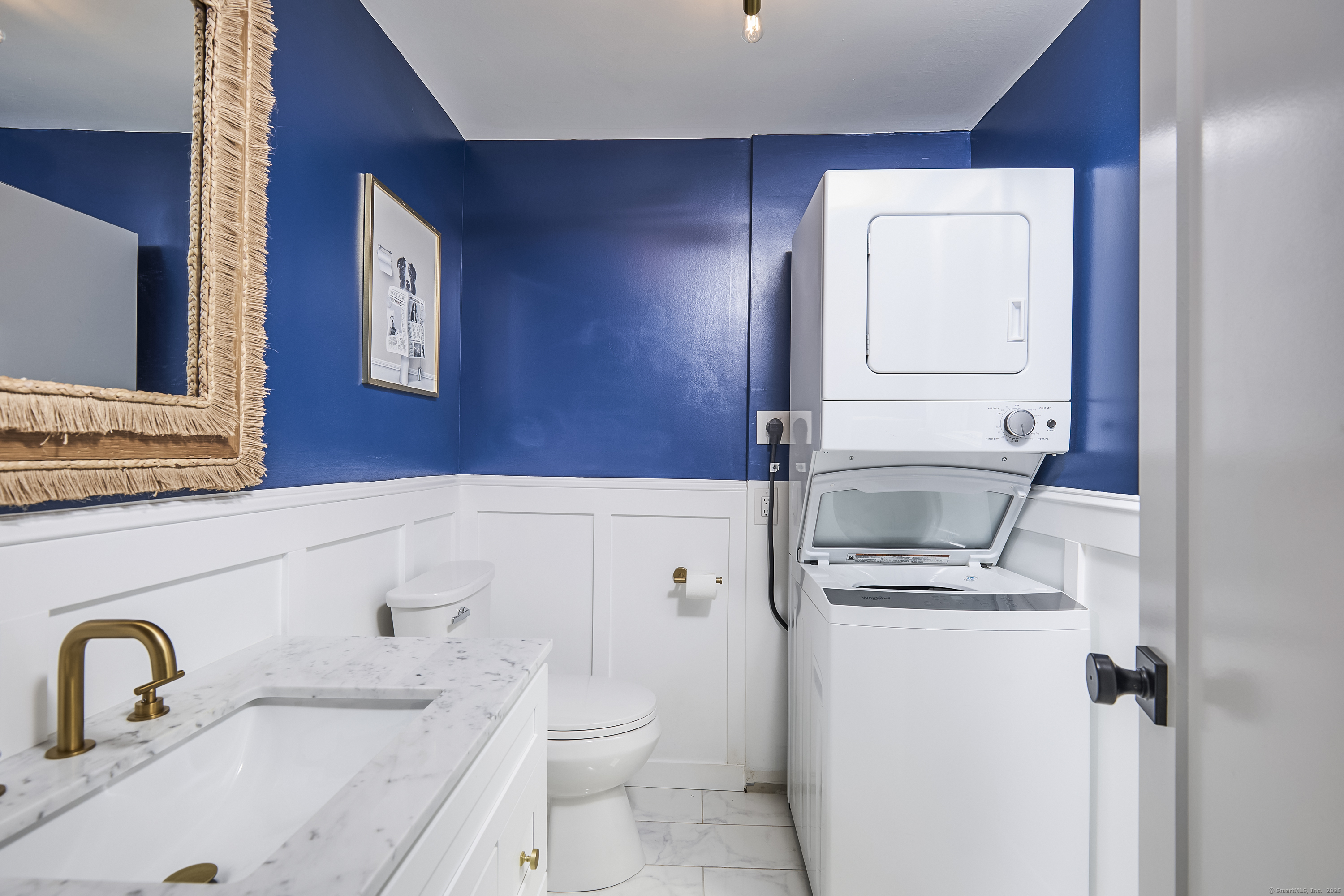 1207 Stillson Road Fairfield, CT 06824 - Photo 19 of 39 a bathroom with a sink toilet and mirror