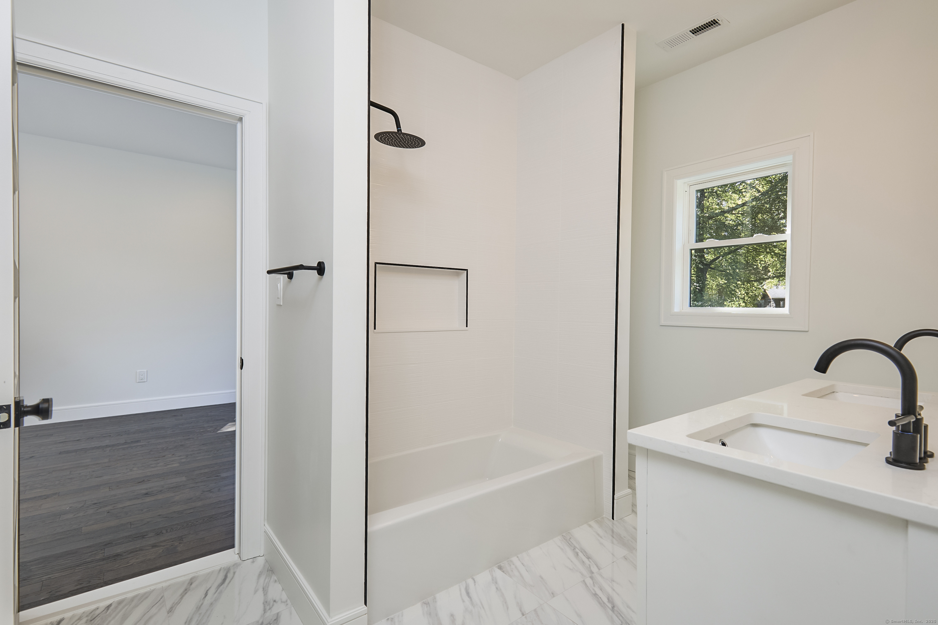 1207 Stillson Road Fairfield, CT 06824 - Photo 26 of 39 a bathroom with a tub sink and a mirror