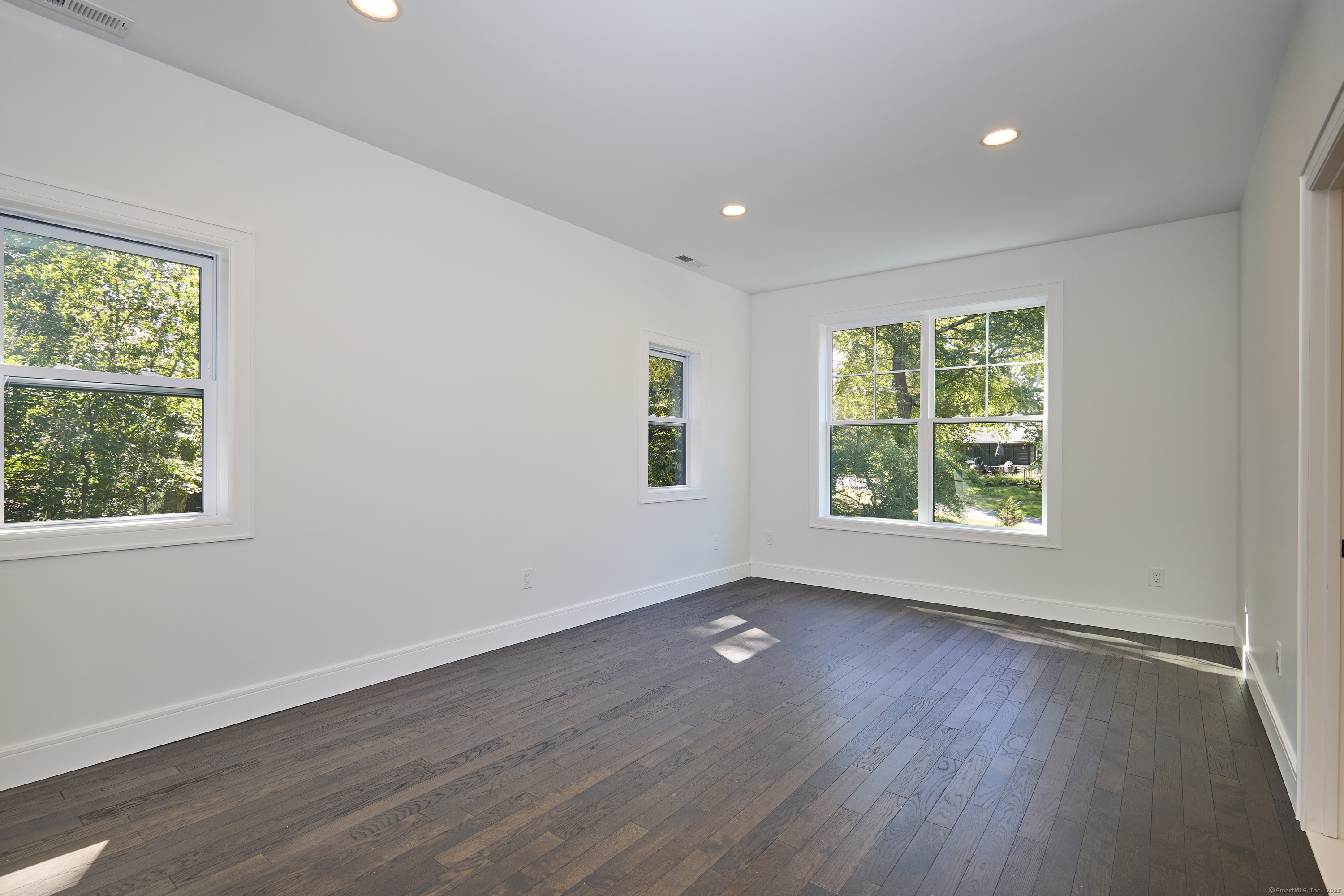 1207 Stillson Road Fairfield, CT 06824 - Photo 28 of 39 an empty room with wooden floor and windows