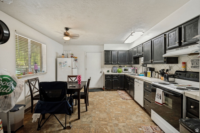 6709 Acoma Road, Unit 239 Midvale, UT 84047 - Photo 27 of 38 6709 - Kitchen featuring black cabinetry, white countertops, tile backsplash, and a ceiling fan