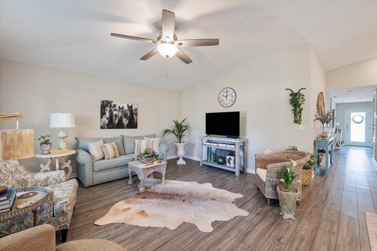 709 Riverwalk Circle Freeport, FL 32439 - Photo 12 of 28 a living room with furniture and a flat screen tv