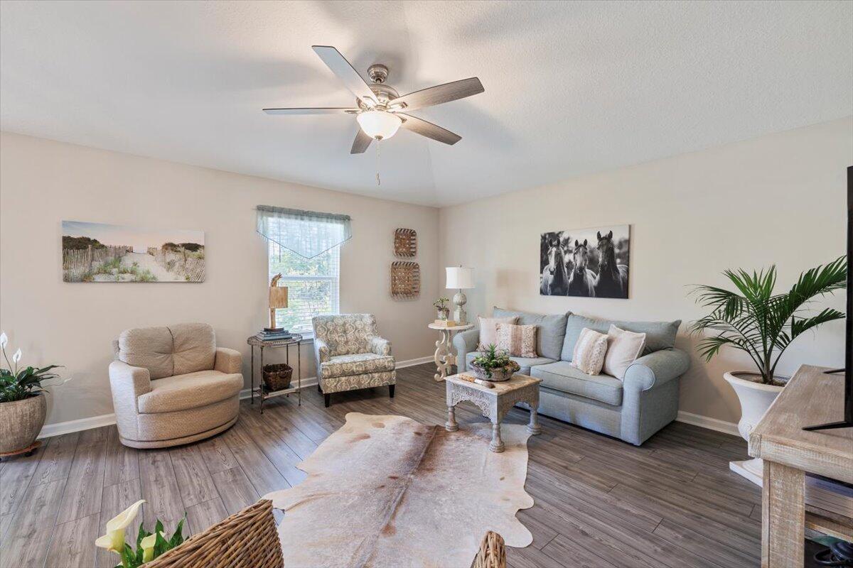 709 Riverwalk Circle Freeport, FL 32439 - Photo 13 of 28 a living room with furniture or couch and a wooden floor