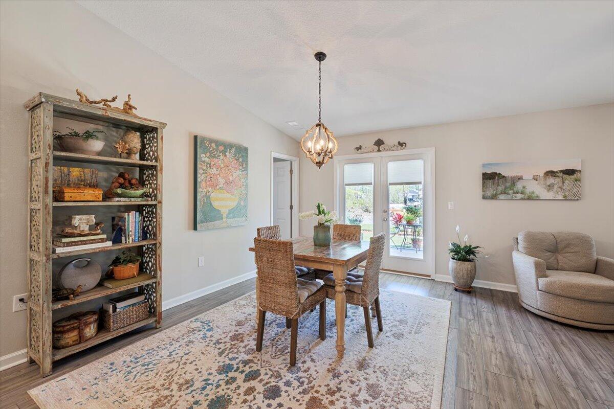 709 Riverwalk Circle Freeport, FL 32439 - Photo 14 of 28 a view of a dining room with furniture window and wooden floor