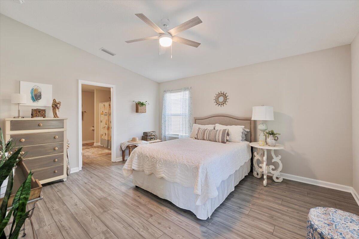709 Riverwalk Circle Freeport, FL 32439 - Photo 17 of 28 a bedroom with a bed and a dresser