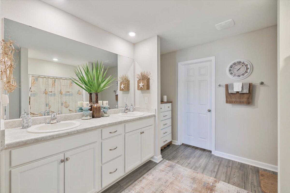 709 Riverwalk Circle Freeport, FL 32439 - Photo 19 of 28 a spacious bathroom with a double vanity sink and a mirror