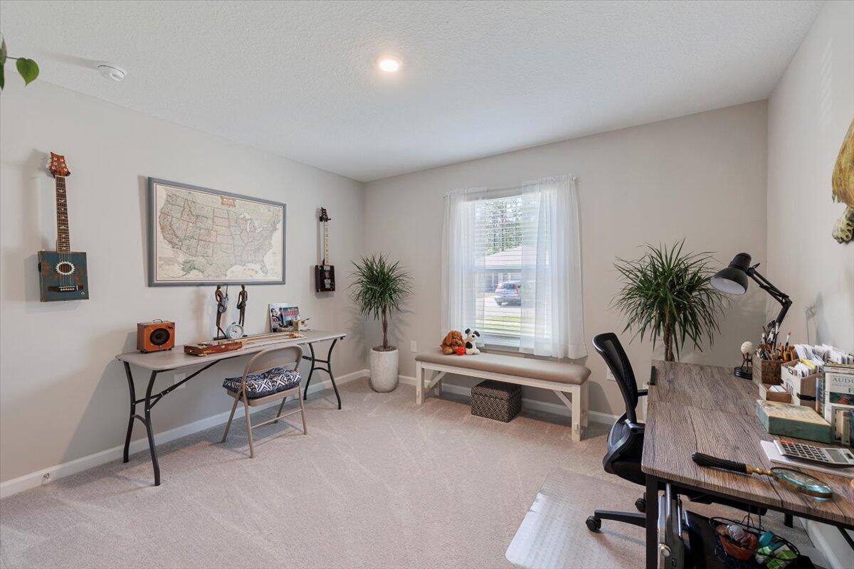 709 Riverwalk Circle Freeport, FL 32439 - Photo 2 of 28 a living room with furniture and a potted plant