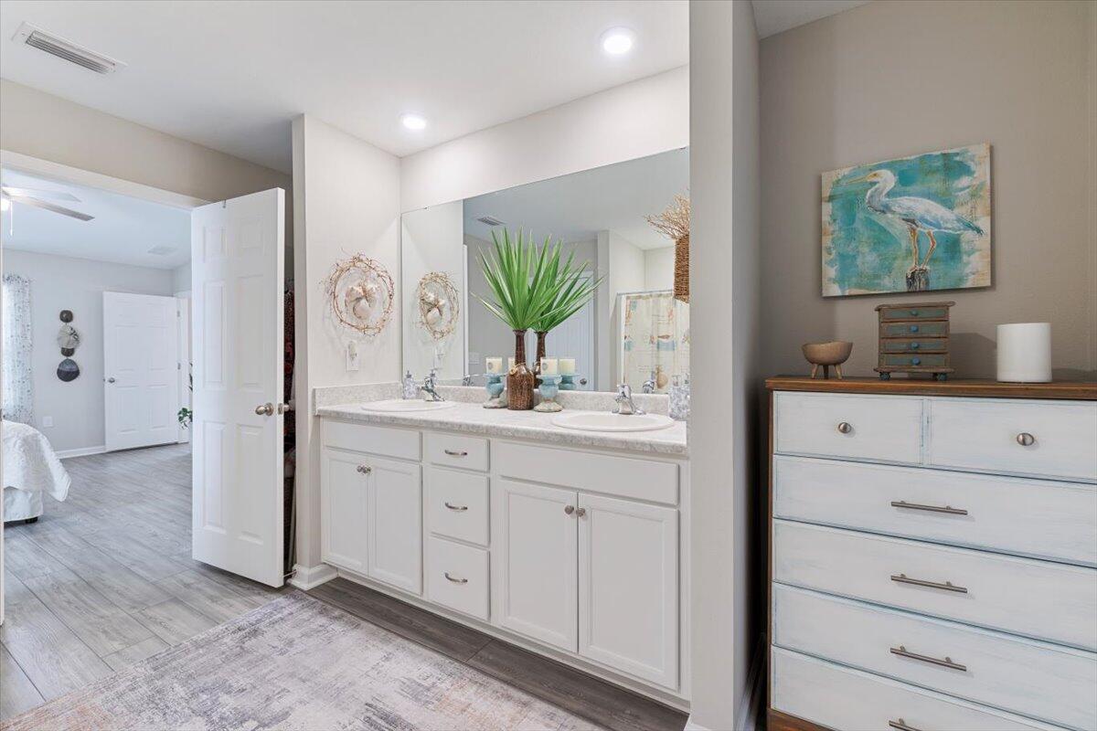 709 Riverwalk Circle Freeport, FL 32439 - Photo 21 of 28 a bathroom with a double vanity sink mirror and toilet