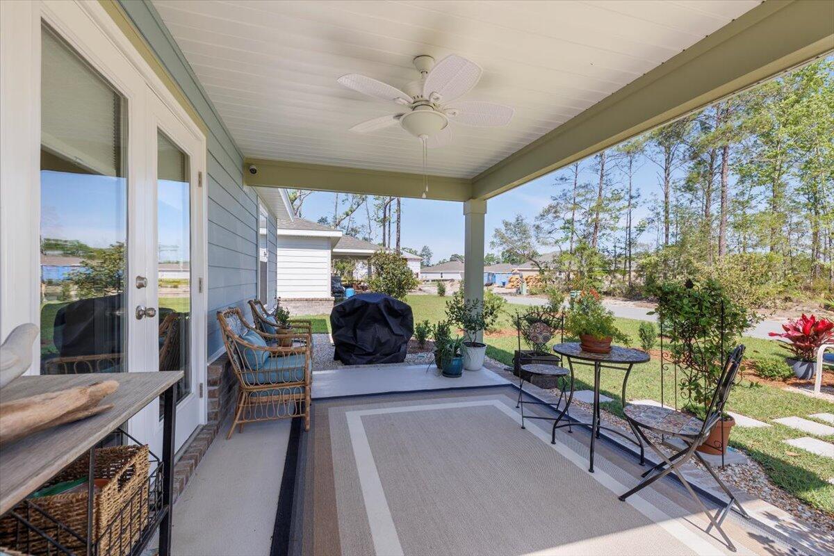 709 Riverwalk Circle Freeport, FL 32439 - Photo 22 of 28 a living room with furniture a fireplace and a table