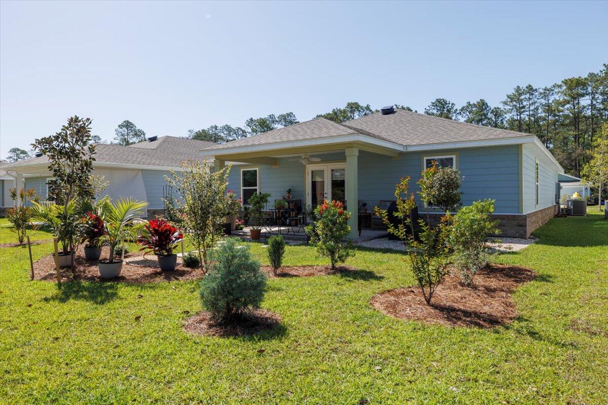 709 Riverwalk Circle Freeport, FL 32439 - Photo 24 of 28 a view of a house with a backyard and sitting area