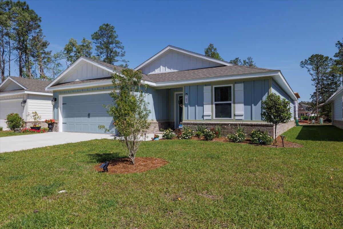 709 Riverwalk Circle Freeport, FL 32439 - Photo 27 of 28 a front view of a house with a yard and garage