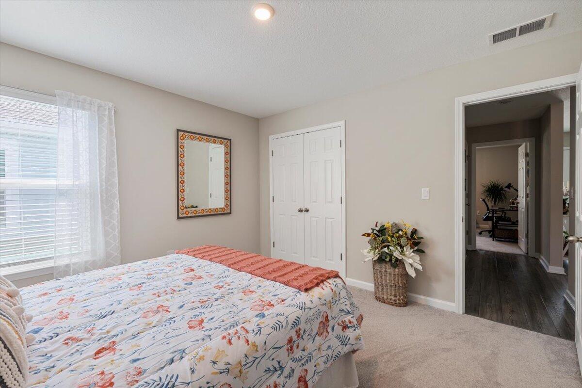 709 Riverwalk Circle Freeport, FL 32439 - Photo 5 of 28 a bedroom with a bed and a potted plant