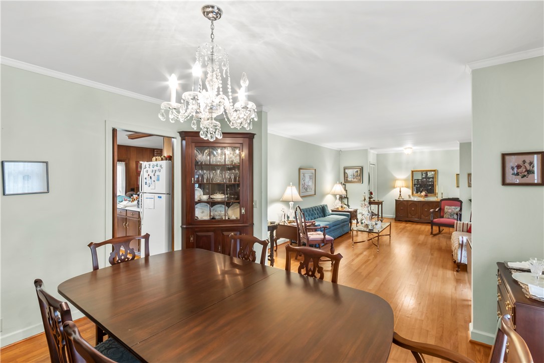 118 Blair Road Belton, SC 29627 - Photo 12 of 49 Warm hardwood floors connect a formal dining space to the open living room.